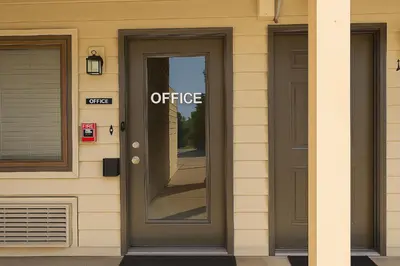 an office sign on the door of a building at Paragon Inn Hillsboro in Hillsboro