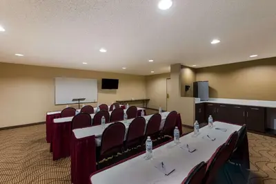 a conference room with a table and chairs and a screen at Quality Inn Marysville in Marysville