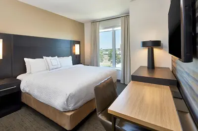 a hotel room with a bed and a desk and a television at Residence Inn by Marriott Cleveland University Circle/Medical Center in Cleveland