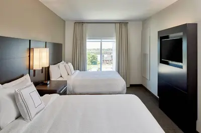 a hotel room with two beds and a television at Residence Inn by Marriott Cleveland University Circle/Medical Center in Cleveland