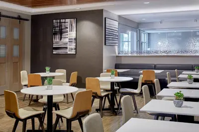 a dining room with white tables and chairs at Residence Inn by Marriott Cleveland University Circle/Medical Center in Cleveland