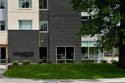 a building with a green lawn in front of it at Residence Inn by Marriott Cleveland University Circle/Medical Center in Cleveland