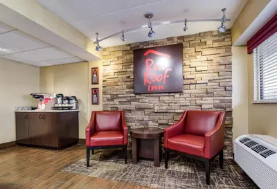 a waiting room with two chairs and a red roof inn sign at Red Roof Inn Lexington in Lexington