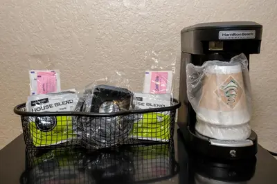 a basket of food and a coffee maker on a table at Red Roof Inn Lexington in Lexington