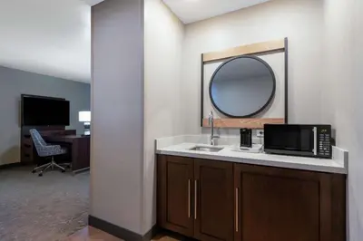 a bathroom with a sink and a mirror at Hampton Inn & Suites Fort Wayne Downtown in Fort Wayne