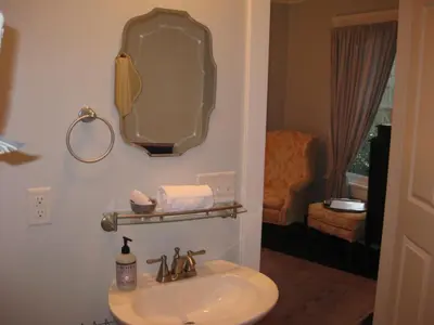 a bathroom with a sink and a mirror at Riverside Gables Bed and Breakfast in Berea
