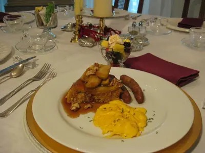 a white plate of food on a table at Riverside Gables Bed and Breakfast in Berea