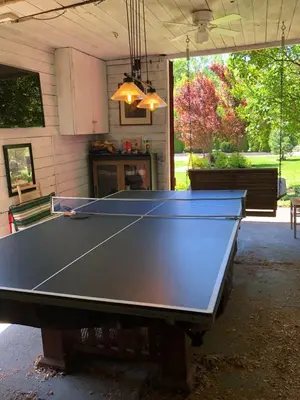 a ping pong table in a garage at Riverside Gables Bed and Breakfast in Berea