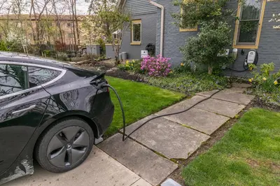 a car with a hose attached to it parked in a yard at Riverside Gables Bed and Breakfast in Berea