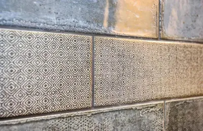 a stone wall with a pattern on it at Indigo Pass Boutique Hotel in Middletown