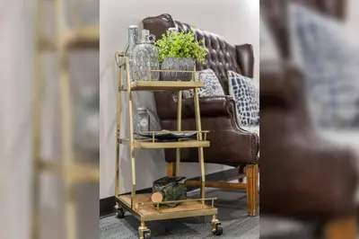 a wooden shelf with a plant and a chair at Indigo Pass Boutique Hotel in Middletown