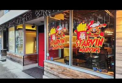 a store with signs in the window of a restaurant at Indigo Pass Boutique Hotel in Middletown