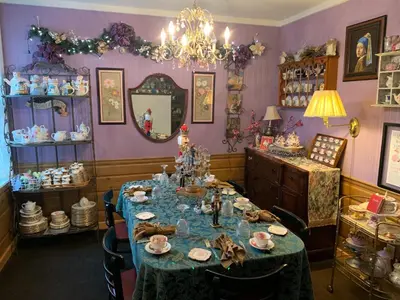 a dining room with a table and a mirror at Emerald Necklace Inn Bed and Breakfast in Lakewood