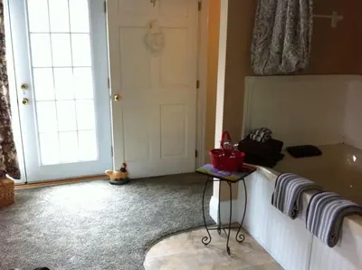 a room with a door and a table with towels at Emerald Necklace Inn Bed and Breakfast in Lakewood