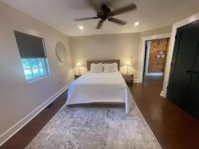 a bedroom with a bed and a ceiling fan at Pine Creek Cabins & Camping Resort in South Bloomingville