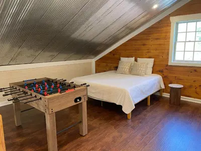 a bedroom with a bed and a chess board on a table at Pine Creek Cabins & Camping Resort in South Bloomingville