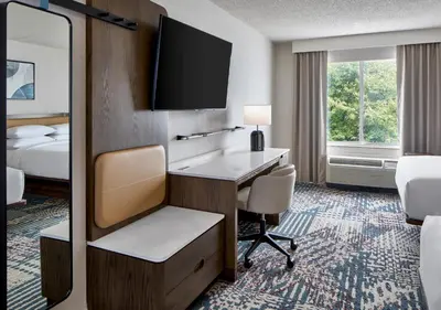 a hotel room with a desk and a television at Delta Hotels by Marriott Toledo in Toledo
