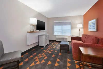 a living room with a couch and a tv at Holiday Inn & Suites - Toledo Southwest - Perrysburg by IHG in Perrysburg