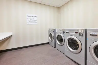 a laundry room with two washing machines in it at Holiday Inn & Suites - Toledo Southwest - Perrysburg by IHG in Perrysburg
