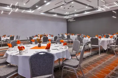 a conference room with white tables and chairs at Holiday Inn & Suites - Toledo Southwest - Perrysburg by IHG in Perrysburg