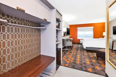 a hotel room with a bed and a desk at Holiday Inn & Suites - Toledo Southwest - Perrysburg by IHG in Perrysburg
