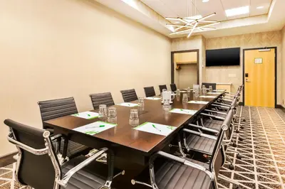 a large conference room with a long table and chairs at Holiday Inn & Suites - Toledo Southwest - Perrysburg by IHG in Perrysburg