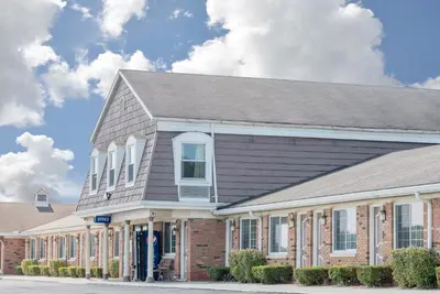 a large brick building with a gray roof at Travelodge by Wyndham Mansfield in Mansfield