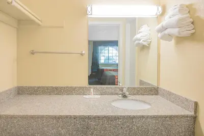 a bathroom with a sink and a mirror at Travelodge by Wyndham Mansfield in Mansfield