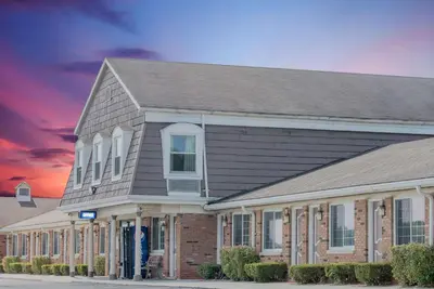 a large building with a house at Travelodge by Wyndham Mansfield in Mansfield
