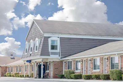 a large brick building with a gray roof at Travelodge by Wyndham Mansfield in Mansfield