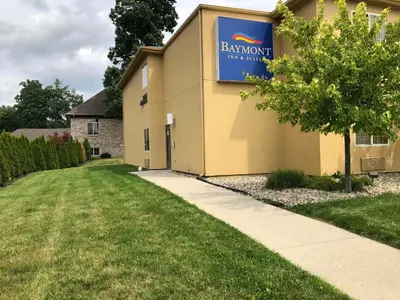 a building with a sign on the side of it at Baymont by Wyndham Fort Wayne in Fort Wayne