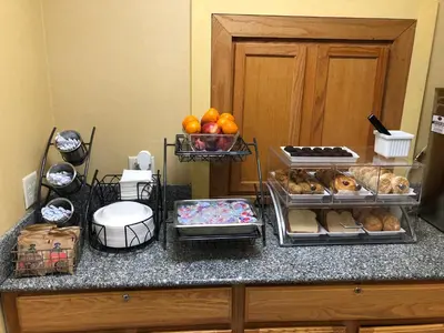 a kitchen counter with a bunch of food on it at Baymont by Wyndham Fort Wayne in Fort Wayne