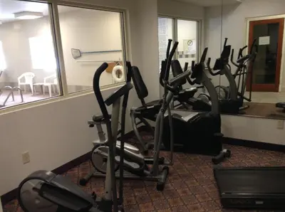 a gym with several exercise bikes in a room at Baymont by Wyndham Fort Wayne in Fort Wayne