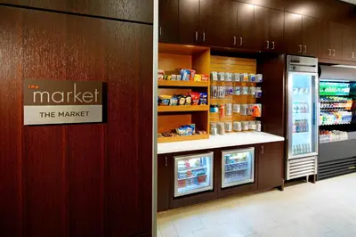 a grocery store with a refrigerator and a counter at Courtyard Cleveland University Circle in Cleveland