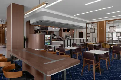a restaurant with tables and chairs and a bar at Courtyard Cleveland University Circle in Cleveland