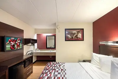 a hotel room with a bed and a sink at Red Roof Inn Dayton - Fairborn/Nutter Center in Fairborn
