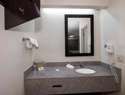 a bathroom with a sink and a phone at Red Roof Inn Dayton - Fairborn/Nutter Center in Fairborn