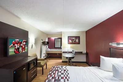 a hotel room with a bed and a tv at Red Roof Inn Dayton - Fairborn/Nutter Center in Fairborn