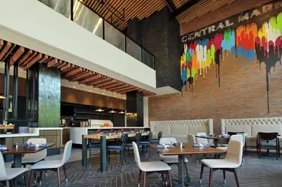 a restaurant with tables and chairs and a brick wall at Canopy By Hilton Columbus Downtown Short North in Columbus