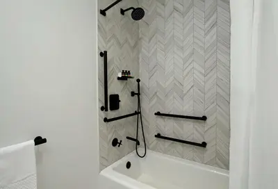 a bathroom with a shower with a white tub at Canopy By Hilton Columbus Downtown Short North in Columbus