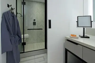 a bathroom with a shower with a glass door at Canopy By Hilton Columbus Downtown Short North in Columbus