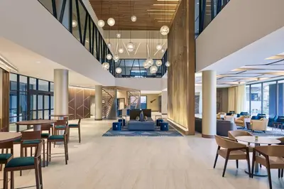 an office lobby with tables and chairs and a lobby at Delta Hotels by Marriott Ashland Downtown in Ashland
