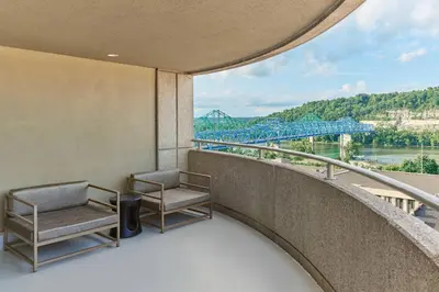 a balcony with two chairs and a view of a bridge at Delta Hotels by Marriott Ashland Downtown in Ashland