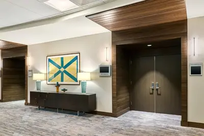 a lobby of a hotel with a reception desk and a door at Delta Hotels by Marriott Ashland Downtown in Ashland