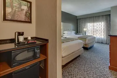 a hotel room with two beds and a television at Drury Inn & Suites Cleveland Beachwood in Beachwood