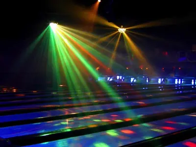 a lit up bowling alley with lights on it at Cedar Stables Inn & Suites in Sandusky