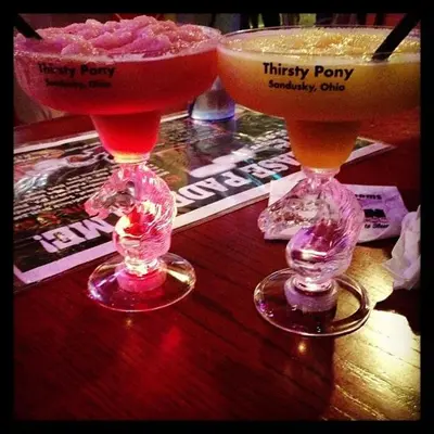 two cocktails sitting on a table with aasy at Cedar Stables Inn & Suites in Sandusky