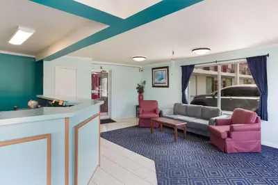 a living room with a couch and two chairs at Rodeway Inn South Point in South Point