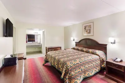 a hotel room with a bed and a television at Rodeway Inn South Point in South Point
