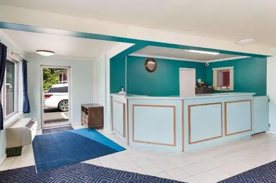 a living room with a blue wall at Rodeway Inn South Point in South Point